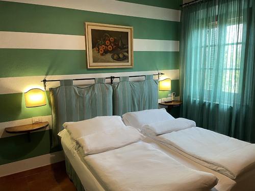 a bedroom with a bed with two pillows on it at Agriturismo Il Poggiarello in Siena