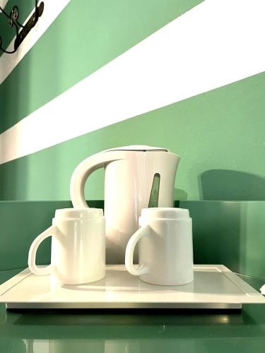 three white coffee mugs sitting on a tray at Agriturismo Il Poggiarello in Siena