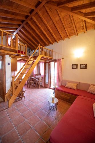 a living room with a staircase in a house at Katikies Stamatias Studios & Maisonettes in Agnontas