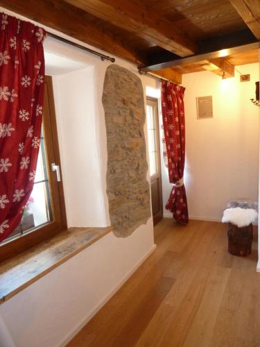 a room with a stone wall and a window at BeB LUCA76 in Avise