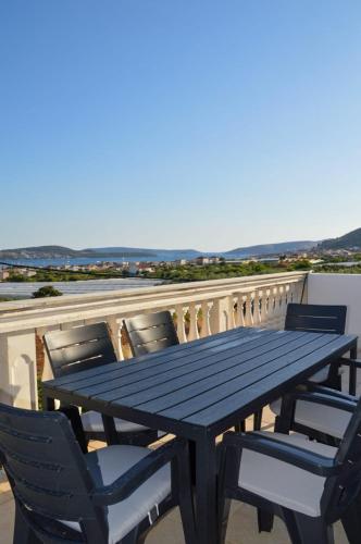 a black picnic table and chairs on a balcony at Apartment Blanka with a beautiful view of Trogir in Trogir