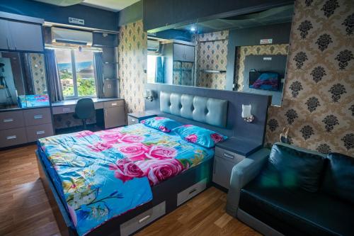 a bedroom with a bed with pink roses on it at Apartemen Soekarno Hatta by Easy Staycation 4 in Malang