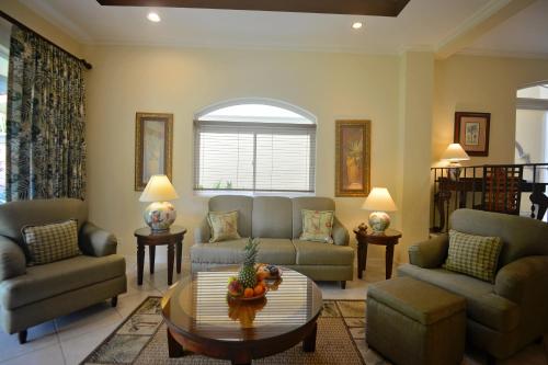 a living room with two couches and a table at HRG Condos at Los Sueños in Jacó