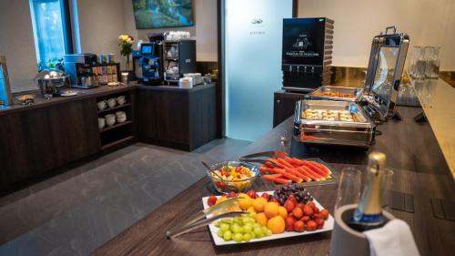 a buffet with fruits and vegetables on a counter at HOTEL Hraniční zámeček in Hlohovec