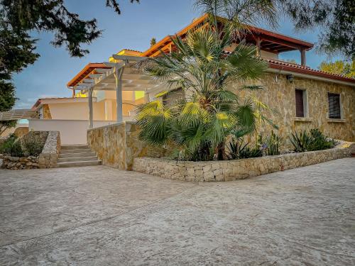 a house with a palm tree in front of it at Residence Dolce Vita in Torre Lapillo