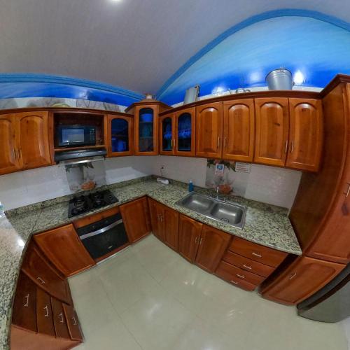 an overhead view of a kitchen with wooden cabinets at Posada Faych House in San Andrés