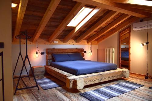 a bedroom with a bed on a wooden floor at La Volta - Molino Maufet Mühle - Patio on the garden in Colico