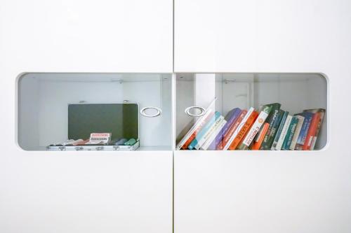 a collage of two images of a book shelf with books at Young Backpackers Homestay in Luzern