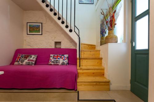 a purple couch in a room with stairs at Apartment Gorki in Split