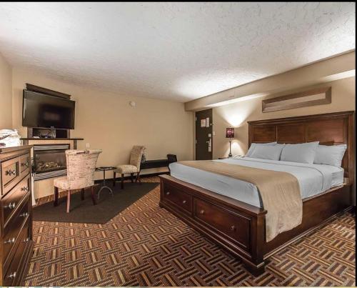 a hotel room with a bed and a flat screen tv at Wyndham Garden Medicine Hat Conference Center in Medicine Hat