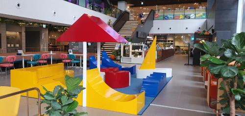 a mall with a playground in the middle of a building at Sangsang Stay Busan in Busan