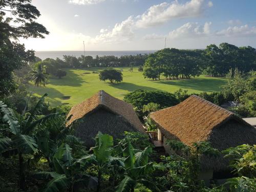 an aerial view of a golf course with two huts at Rainbow Villas in Rarotonga