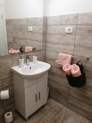 a bathroom with a sink and a mirror at Apartmani Nevera in Krk