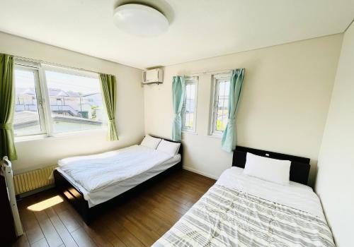 Postel nebo postele na pokoji v ubytování Chitose Guest House Oukaen