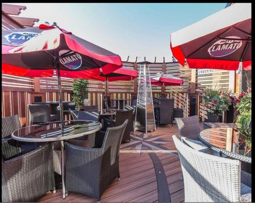 a patio with tables and chairs and umbrellas at Wyndham Garden Medicine Hat Conference Center in Medicine Hat