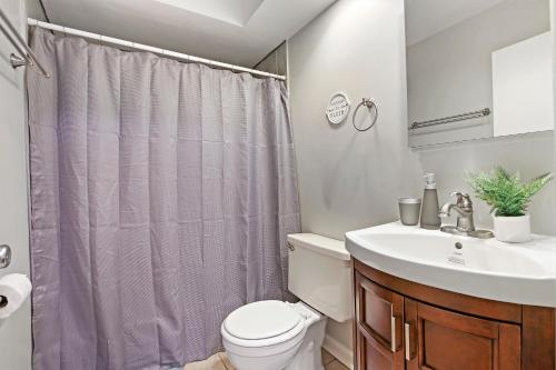 a bathroom with a toilet and a sink at Spacious 2BR Apt in Lakeview near Restaurants - Oakdale 512 in Chicago