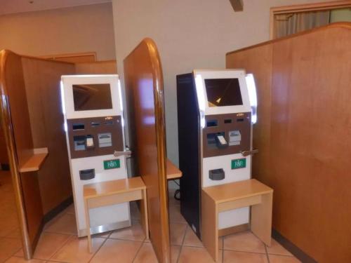 a couple of atm machines sitting next to a mirror at R&B Hotel Kanazawa Station Nishiguchi - Vacation STAY 14972v in Kanazawa