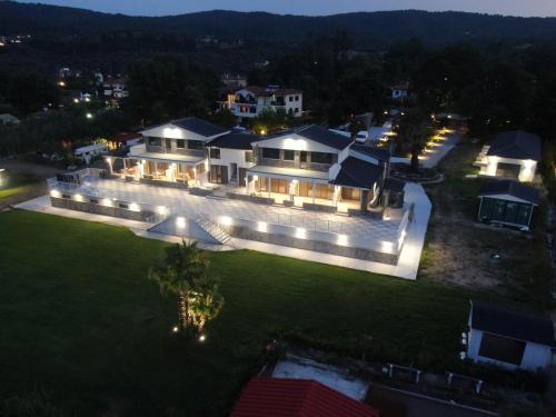 an aerial view of a mansion at night at The Palms novasithonia in Vourvourou