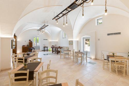 a dining room with tables and chairs in a building at Masseria Villa Verde in Fasano