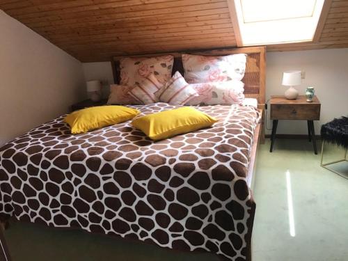 a bedroom with a large bed with yellow pillows at Schöne Ferienwohnung im Südschwarzwald in Herrischried