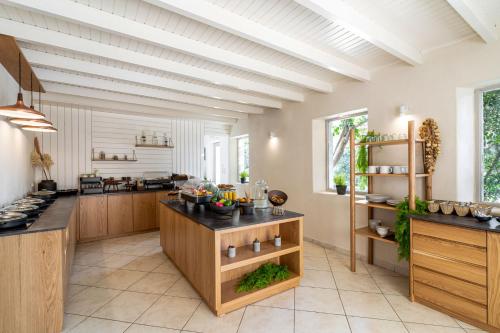 a large kitchen with wooden cabinets and counters at Marillia Village in Perivolos