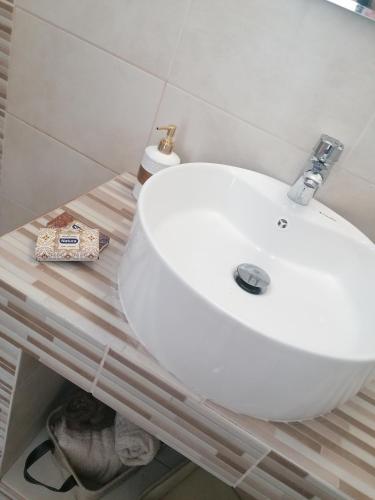 a bathroom with a white sink on a counter at 12 senses faliraki sea view in Faliraki