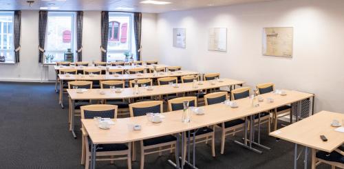 a row of tables and chairs in a room at Hotel Frederikshavn in Frederikshavn