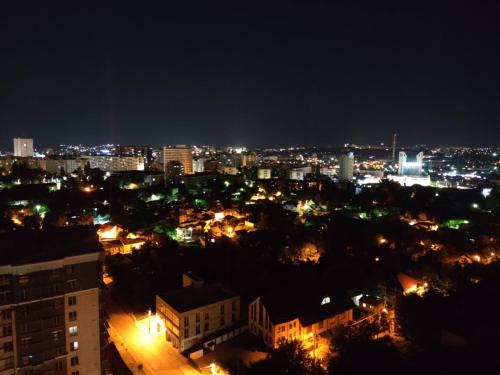 a view of a city at night with lights at Guest House Гостевой Дом in Chişinău