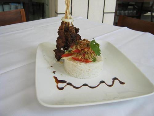 a dessert on a white plate on a table at Vrata Hotel Yogyakarta in Kalasan