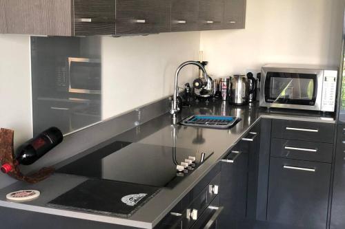 a kitchen with a counter top with a microwave at Aaram Se at My Retreat in Gillingham