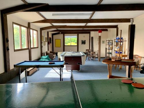 a living room with a ping pong table in it at Honeysuckle Cottage in Ilfracombe