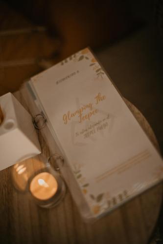 a book and a candle on a table at Glamping The Teepee in Mombeltrán