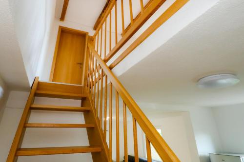 a wooden staircase in a house with a ceiling at Apartment Organic Farm Hvadnik in Tržič