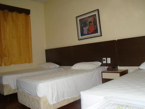 A bed or beds in a room at Brasil Palace Hotel