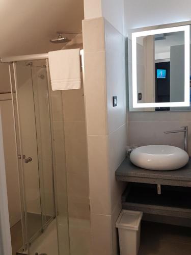 a bathroom with a sink and a glass shower at Villa Glamour in Taormina