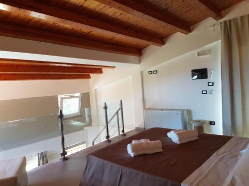 a bedroom with a bed with two towels on it at Villa Glamour in Taormina