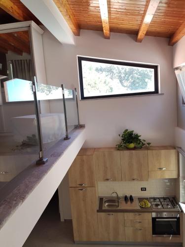 a kitchen with a sink and a stove in a room at Villa Glamour in Taormina