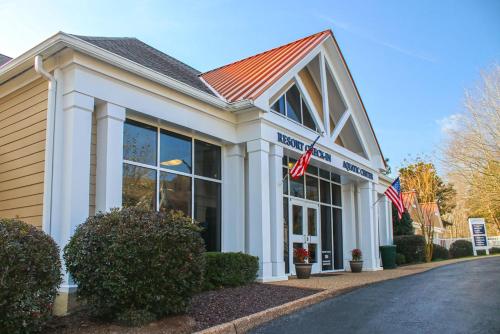 a building with two american flags in front of it at Kings Creek Plantation by Tripforth in Williamsburg