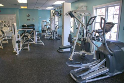 a gym with several tread machines in a room at Kings Creek Plantation by Tripforth in Williamsburg