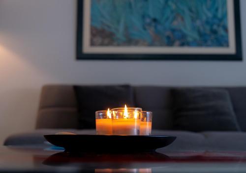 a candle sitting on a table in front of a couch at Kypkeys Apartments in Voroklini