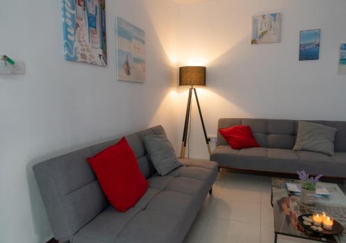 a living room with two couches and a table at Kypkeys Apartments in Voroklini