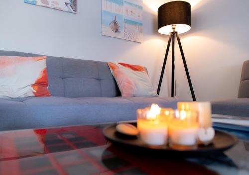 a living room with a couch and candles on a table at Kypkeys Apartments in Voroklini