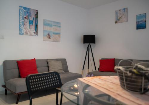 a living room with a couch and a table at Kypkeys Apartments in Voroklini