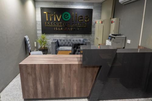 an office with a reception desk with a sign at Trivelles Executive Suites Islamabad in Islamabad