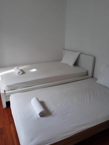 ein weißes Bett mit einer Rolle Toilettenpapier darauf in der Unterkunft 9AM in Tangerang
