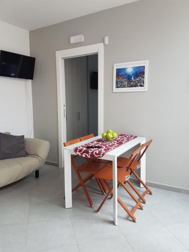 a table with two chairs and a table with fruit on it at Villa Glamour in Taormina