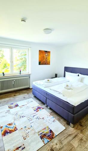 a bedroom with a large bed and a rug at Sanosueno 4 in Sonthofen