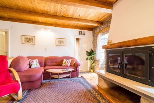 a living room with a couch and a fireplace at House Kočan in Gruda