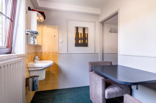 a bathroom with a black table and a sink at B&B Rehoboth in Domburg