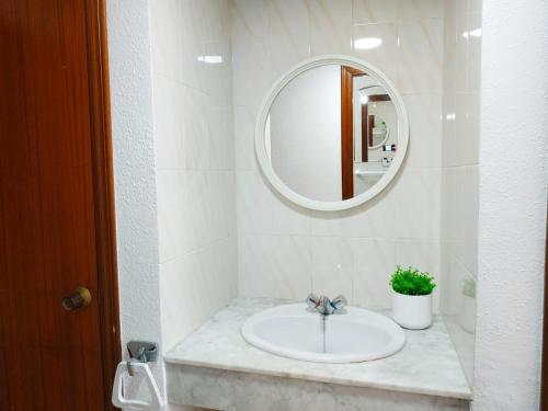 a bathroom with a sink and a mirror at Peñiscola Playa Orangecosta in Peniscola